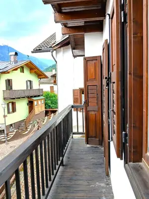 a balcony with a door and a view of a house at Casa Rosetta nel cuore delle Dolomiti in Tonadico
