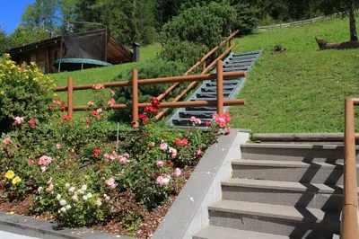 a set of stairs in a garden with flowers at Ciasa La Rösa in Badia