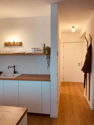 a kitchen with white cabinets and a sink at Braunegg 1 in Brunico