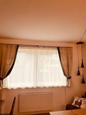 a window with curtains in a living room at Braunegg 1 in Brunico