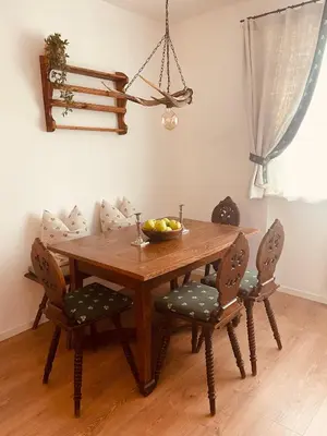 a dining room table with chairs and a bowl of fruit on it at Braunegg 1 in Brunico