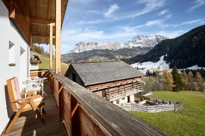 a balcony of a house with a view of mountains at Ciasa Col Cuch in La Villa