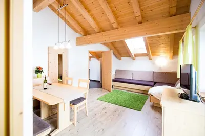 a living room with a couch and a table at Reden Hof in Selva dei Molini