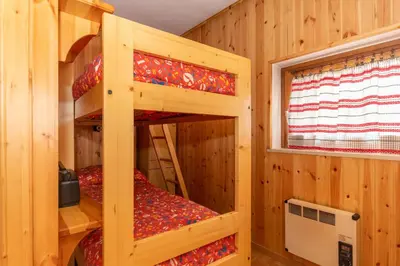 a log cabin with bunk beds in it at Casa Coli in Mazzin
