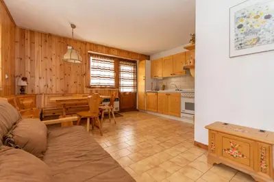 a living room with a table and a dining room at Casa Coli in Mazzin