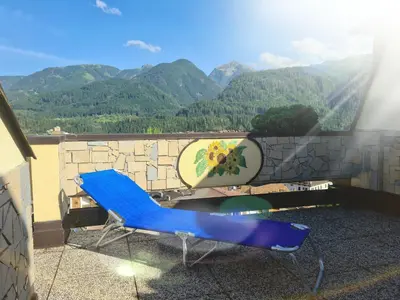 a living room with a couch and a table at TERRAZZA SULLE DOLOMITI in Castello di Fiemme