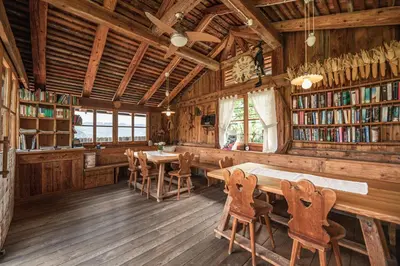 a dining room with tables and chairs in a library at Huebenburg in Appiano sulla Strada del Vino