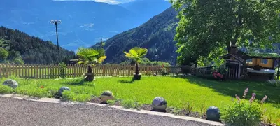 a yard with a fence and a green field at Waldhof in Meltina