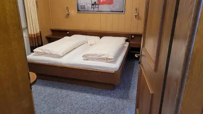 a bedroom with a bed with white pillows on it at Waldhof in Meltina