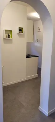 a kitchen with an archway and a white wall at Waldhof in Meltina