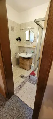 a bathroom with a tub and a sink and a mirror at Waldhof in Meltina