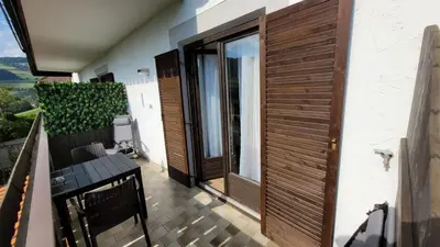 a balcony with a wooden door on a house at Waldhof in Meltina