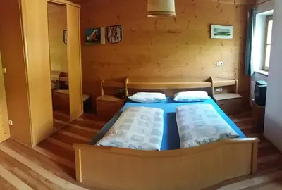a bedroom with a large bed in a wooden room at Verleierhof in Castelrotto