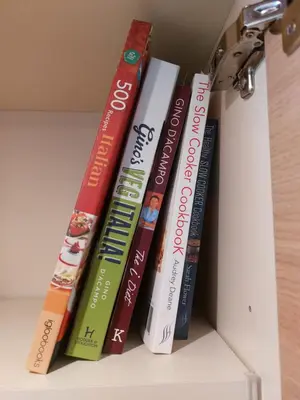 a group of books sitting on a shelf at Italian Apartment with Hot Tub in Arabba