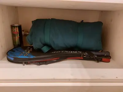 a shelf with a green bag and some other items at Italian Apartment with Hot Tub in Arabba
