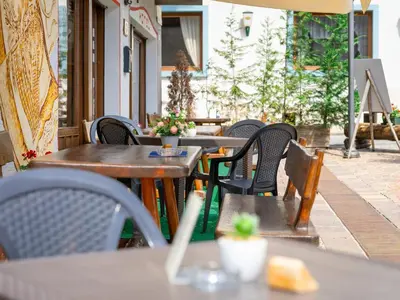 a row of tables and chairs on a patio at Hotel Alle Alpi in Alleghe