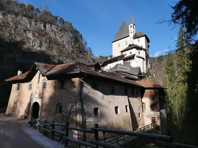 a building with a tower on top of a mountain at Wellness e Resort Stella Delle Alpi in Ronzone