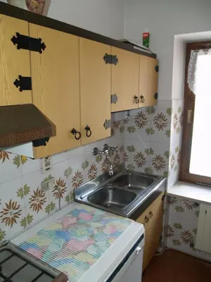 a kitchen with a sink and a counter top at Appartamenti Katinanna in Alleghe