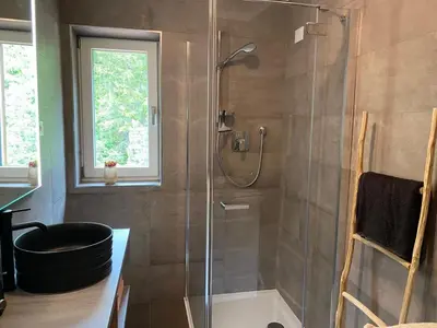 a bathroom with a shower with a glass door at Schneiderhaus in Bagni di Lavina Bianca