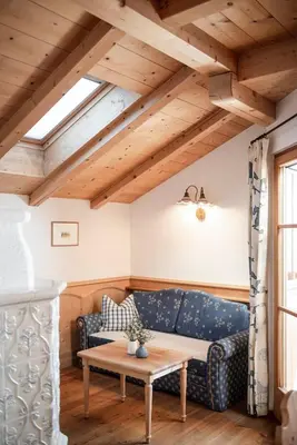 a living room with a blue couch and a table at Radhof in Villandro