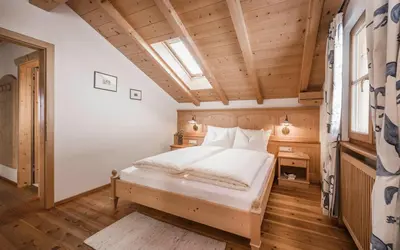 a bedroom with a bed in a room with wooden ceilings at Radhof in Villandro