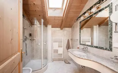a bathroom with a tub and a sink and a mirror at Radhof in Villandro