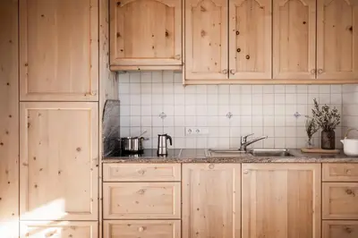 a kitchen with wooden cabinets and a sink at Radhof in Villandro