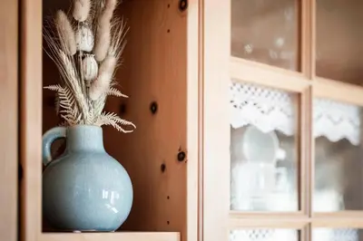 a blue vase sitting on a shelf with a plant in it at Radhof in Villandro