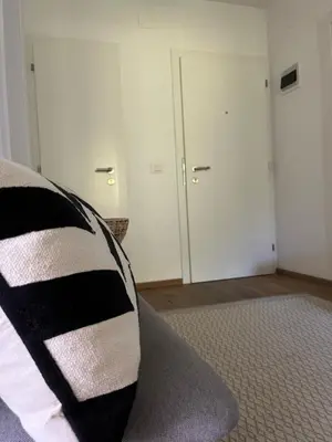 a bedroom with a black and white pillow on a bed at M&M Apartment in Perca