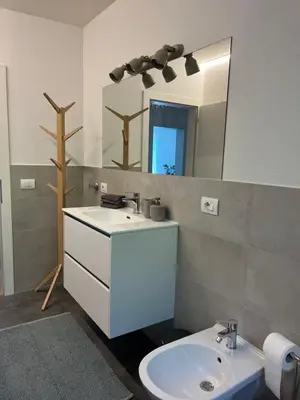 a bathroom with a sink and a mirror at M&M Apartment in Perca