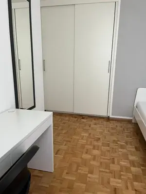 a room with white cabinets and a wooden floor at M&M Apartment in Perca