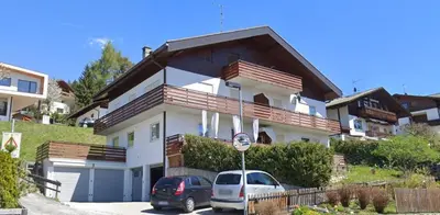 a house with two cars parked in front of it at M&M Apartment in Perca