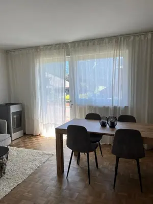 a living room with a table and chairs and a television at M&M Apartment in Perca