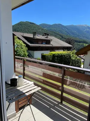a wooden bench sitting on top of a balcony at M&M Apartment in Perca