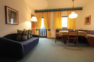a living room with a couch and a table at Residence Baumgartner in Fiè