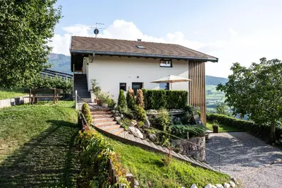 a house on a hill with a fence at Appartements Panorama in Fiè