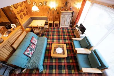 an overhead view of a living room with a couch and a table at Cesa Molin in Campitello di Fassa