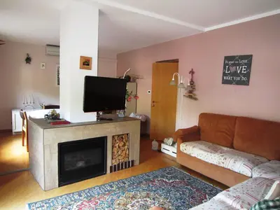 a living room with a couch and a flat screen tv at Casa Caterina in Fiera di Primiero