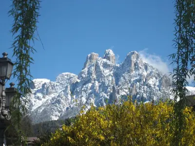 a snow covered mountain in front of a blue sky at Casa Caterina in Fiera di Primiero