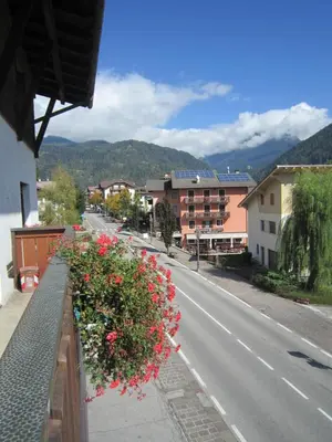 a street with flowers on the side of a road at Casa Caterina in Fiera di Primiero