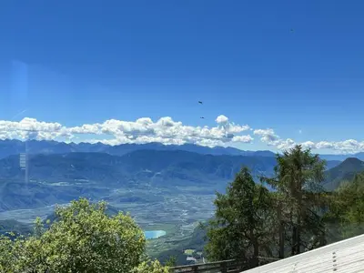 a view of a valley with mountains in the distance at PanoramaHotel Penegal in Mendola