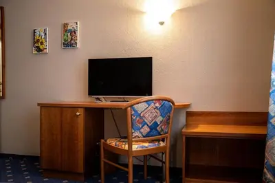 a room with a desk with a computer on it at PanoramaHotel Penegal in Mendola