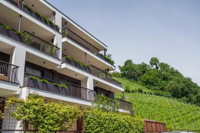 an apartment building with plants on the balconies at Residence Weinberg 8 in Nalles