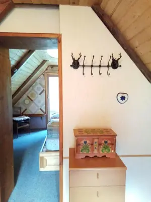 a room with a bed with antlers on the wall at Il nido (Cica) in Sottoguda