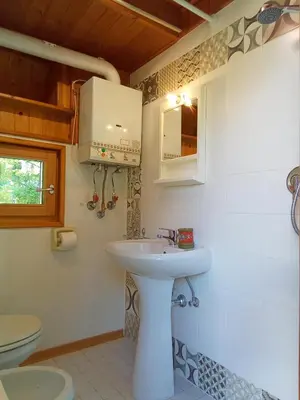 a bathroom with a sink and a toilet at Il nido (Cica) in Sottoguda