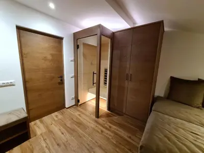a bedroom with a bed and a closet and a door at Chalet Gravina in Ortisei