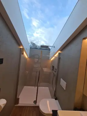 a bathroom with a shower and a toilet at Chalet Gravina in Ortisei