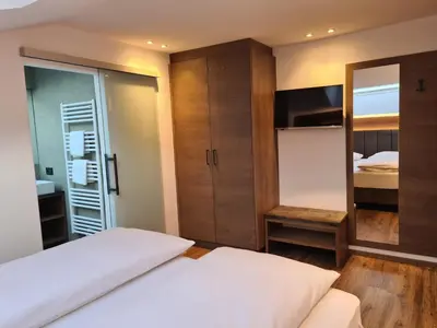 a small bedroom with a bed and a mirror at Chalet Gravina in Ortisei