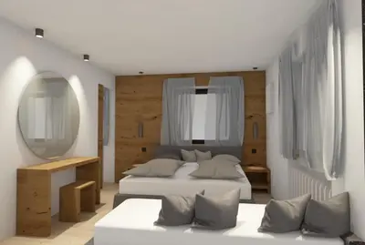 a bedroom with a large bed and a mirror at Chalet Gravina in Ortisei