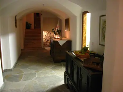 a hallway of a home with a staircase and a room at Messnerwirt Onach in San Lorenzo di Sebato